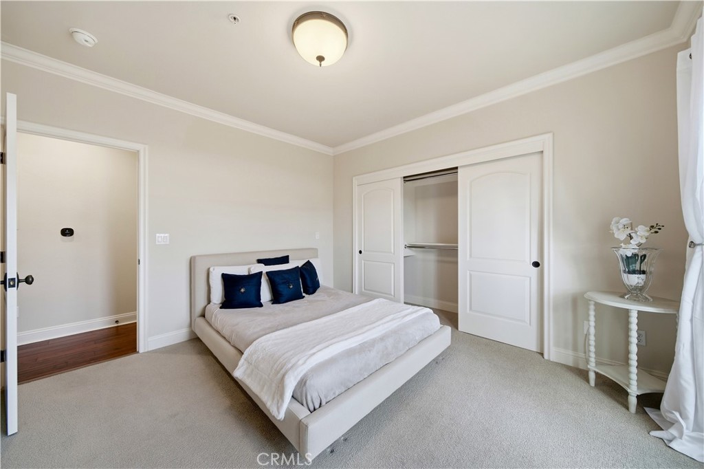 2454 Oswego Street, Unit 301 Pasadena, CA 91107 - Photo 35 of 59 a bedroom with a bed and a chandelier