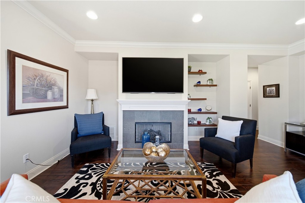 2454 Oswego Street, Unit 301 Pasadena, CA 91107 - Photo 7 of 59 a living room with furniture a flat screen tv and a fireplace