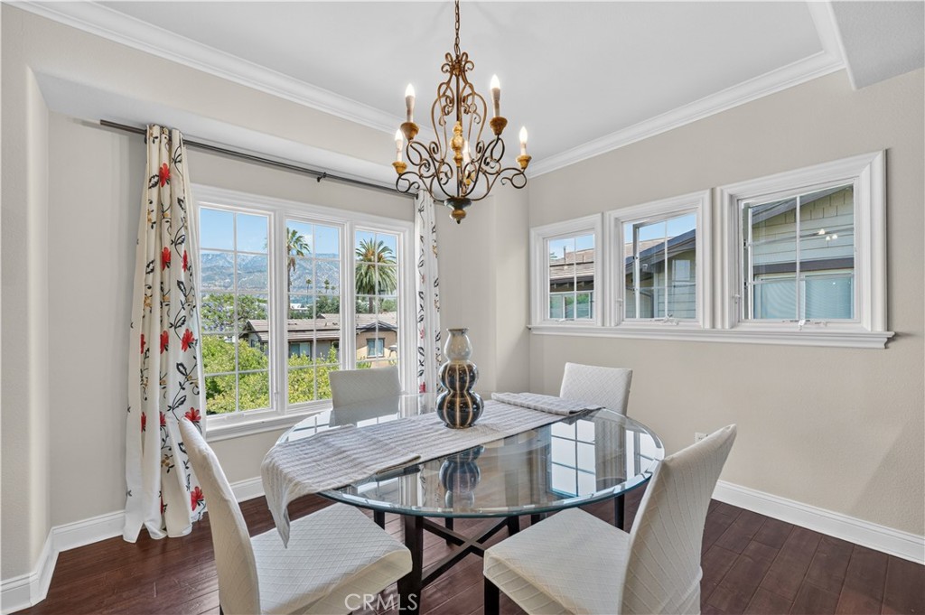 2454 Oswego Street, Unit 301 Pasadena, CA 91107 - Photo 10 of 59 a view of a dining room with furniture a chandelier and wooden floor