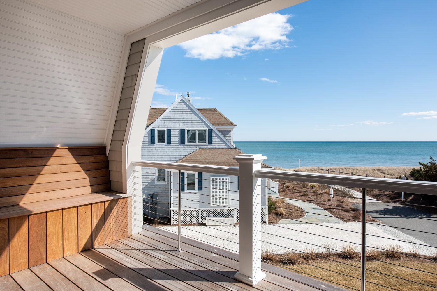 6 Beach Road Mashpee, MA 02649 - Photo 11 of 25 a view of a brick house with a balcony