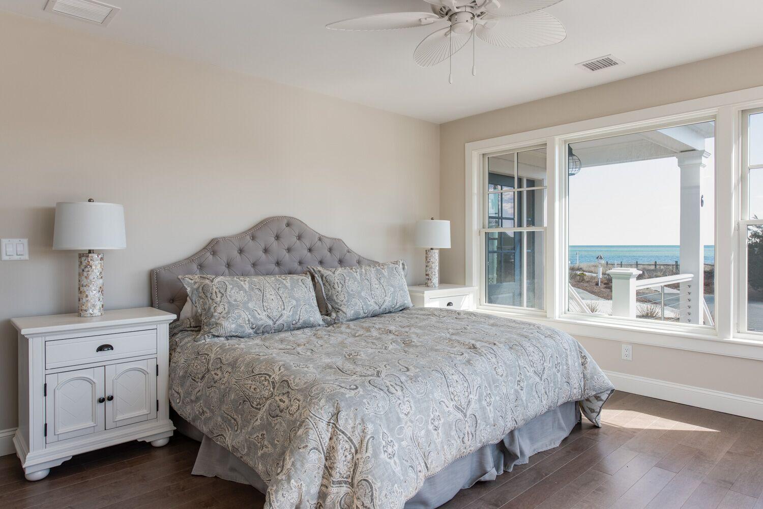 6 Beach Road Mashpee, MA 02649 - Photo 12 of 25 a bedroom with a large bed and a chandelier