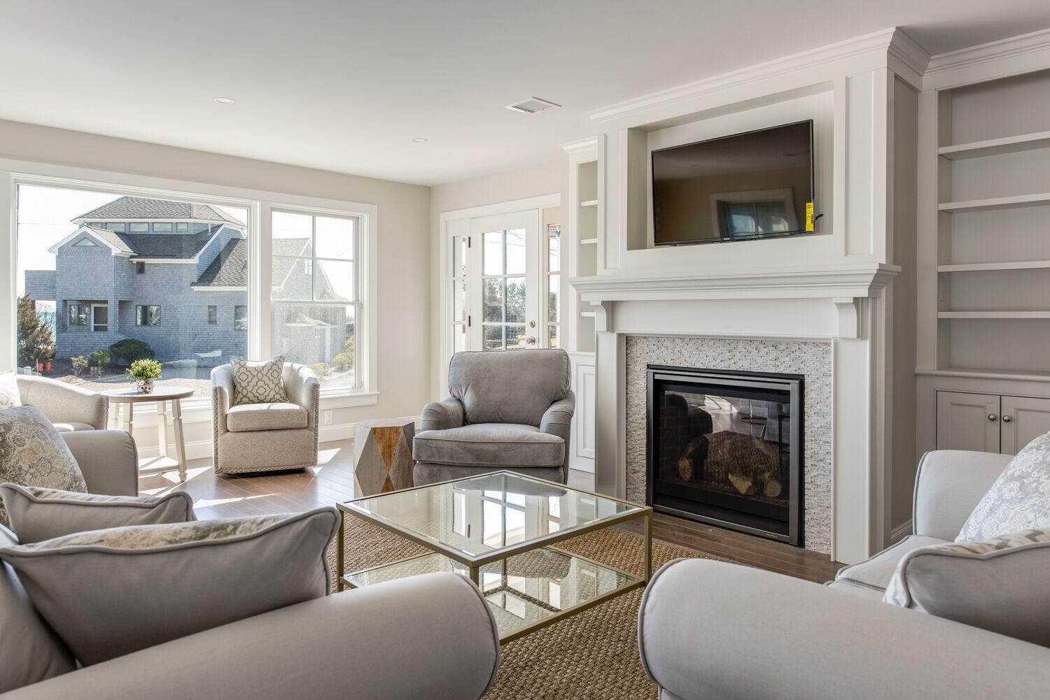 6 Beach Road Mashpee, MA 02649 - Photo 5 of 25 a living room with furniture and a fireplace