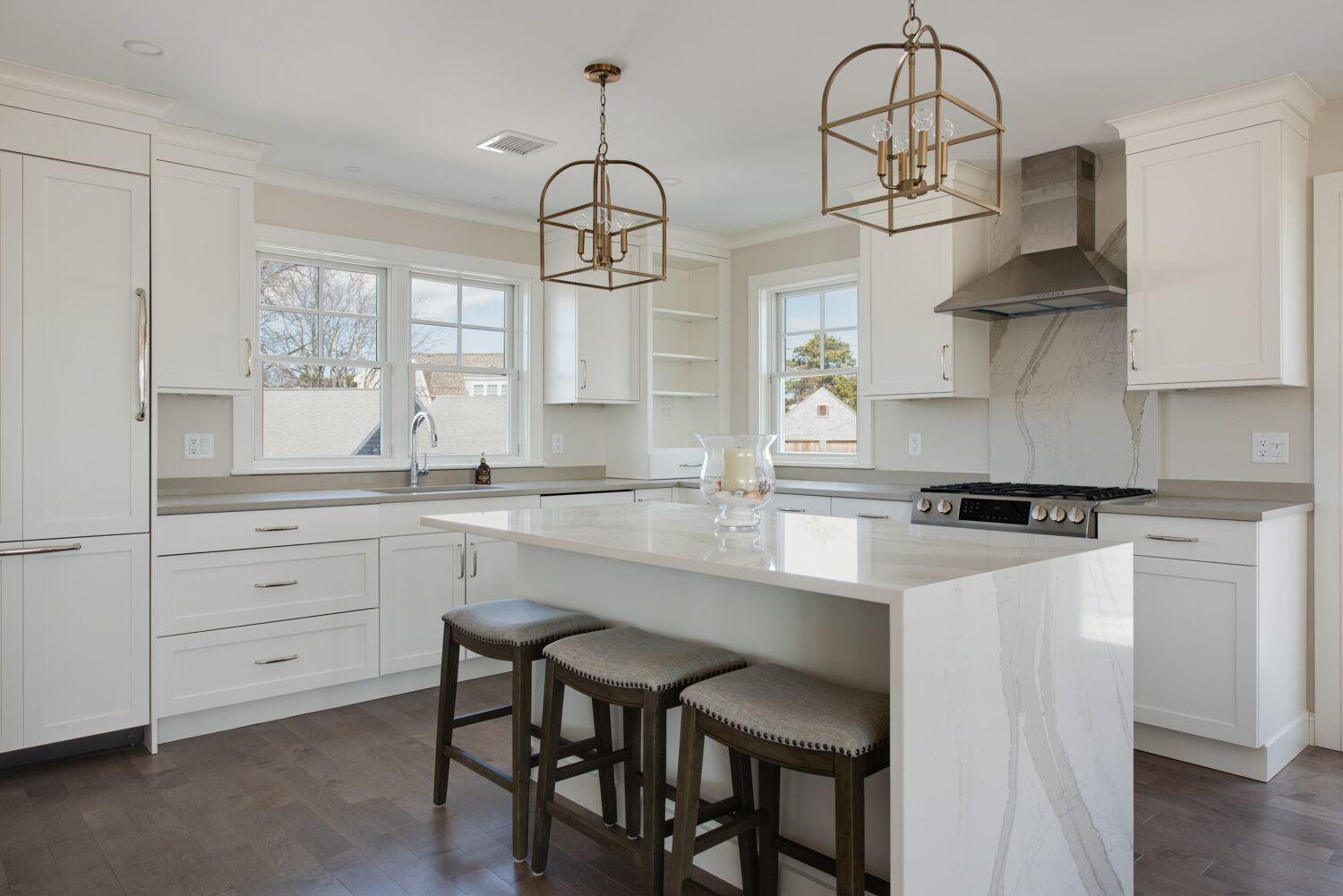 6 Beach Road Mashpee, MA 02649 - Photo 8 of 25 a kitchen with stainless steel appliances a table and chairs in it