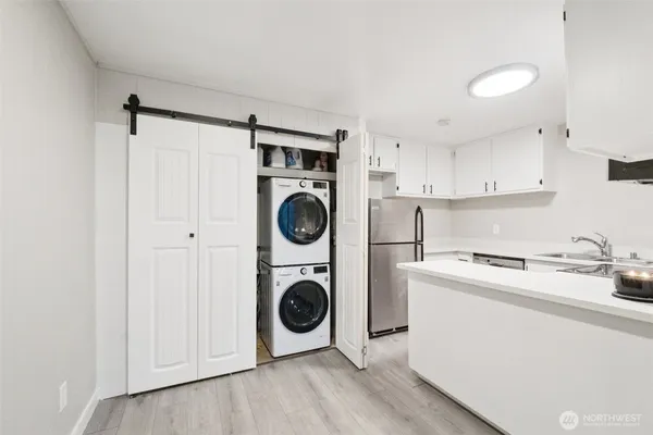 a utility room with sink dryer and washer