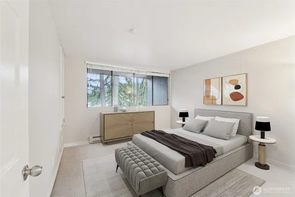 a bedroom with a bed and a window