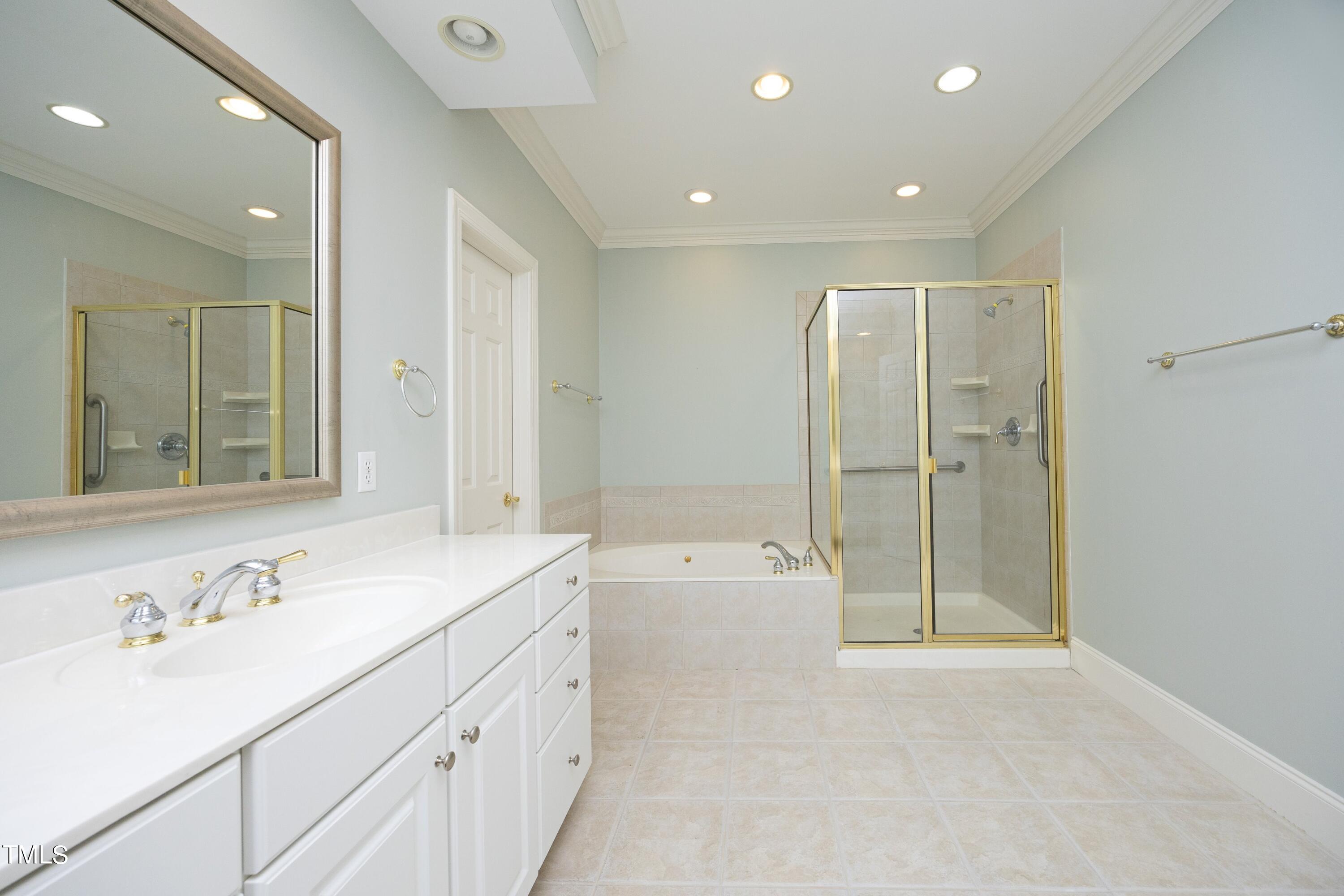 8805 Leeshire Lane Raleigh, NC 27615 - Photo 13 of 26 a spacious bathroom with a shower sink and mirror