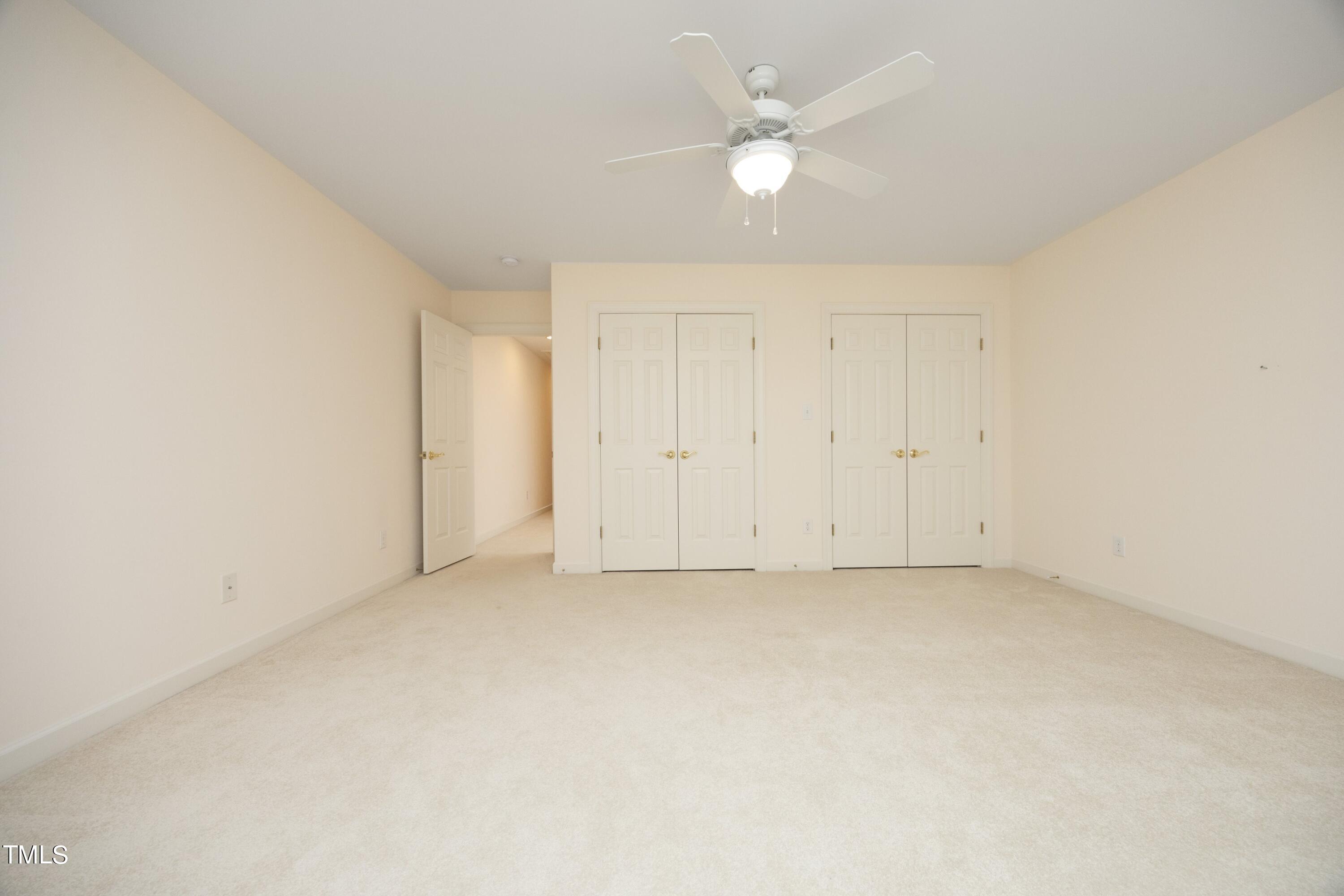 8805 Leeshire Lane Raleigh, NC 27615 - Photo 17 of 26 an empty room with a ceiling fan and a window