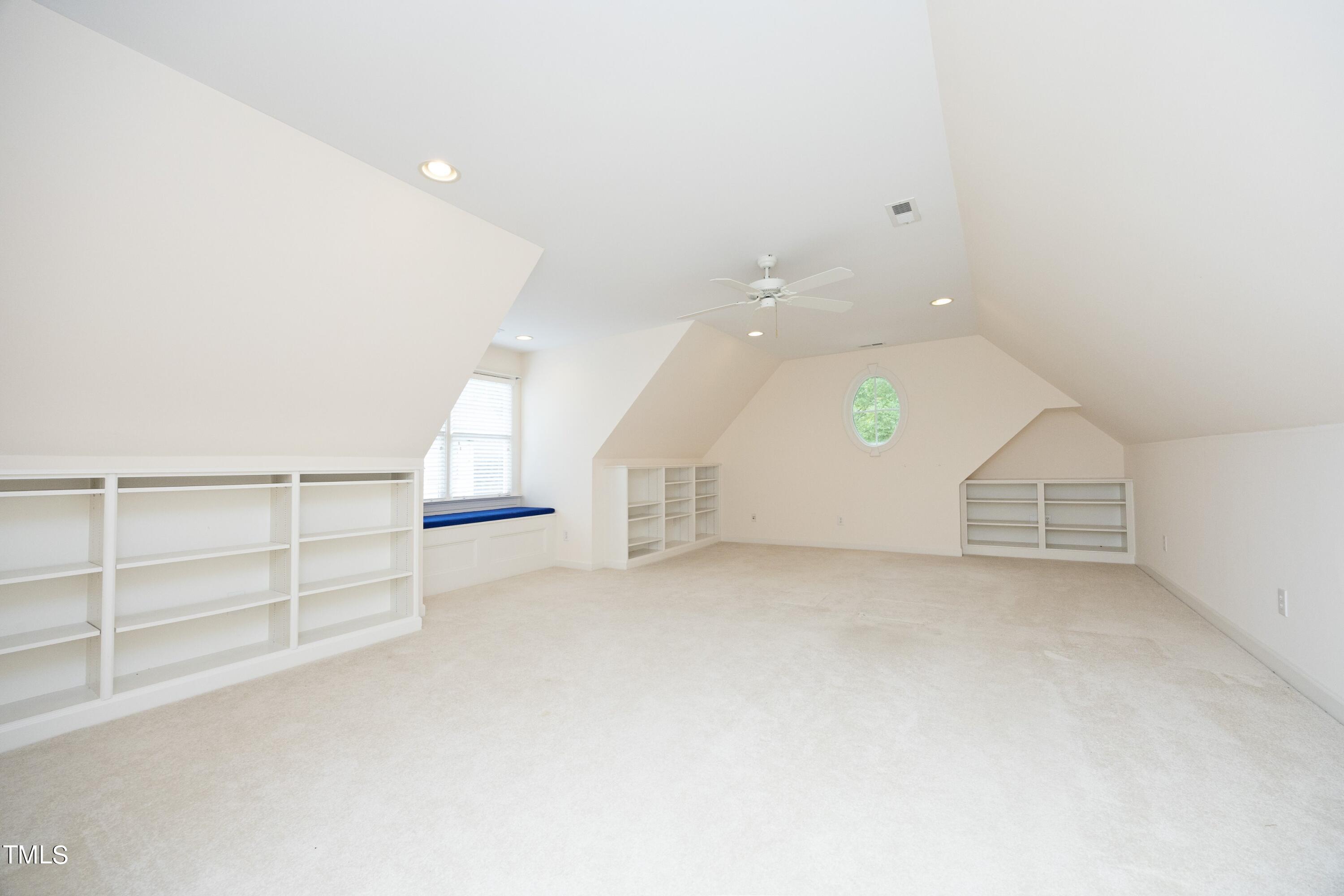8805 Leeshire Lane Raleigh, NC 27615 - Photo 19 of 26 an empty room with windows and pillars in it