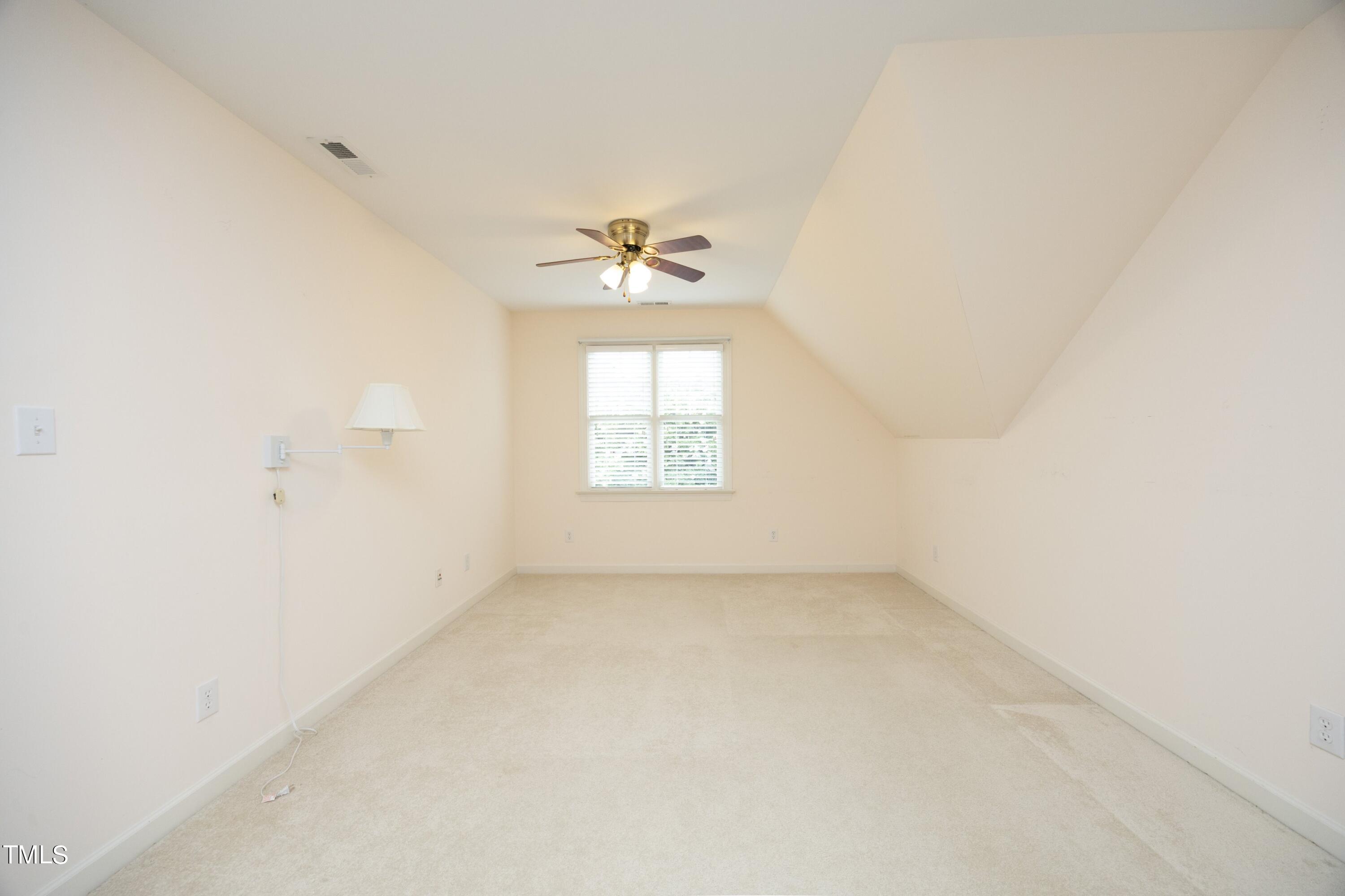 8805 Leeshire Lane Raleigh, NC 27615 - Photo 20 of 26 an empty room with a window and a ceiling fan