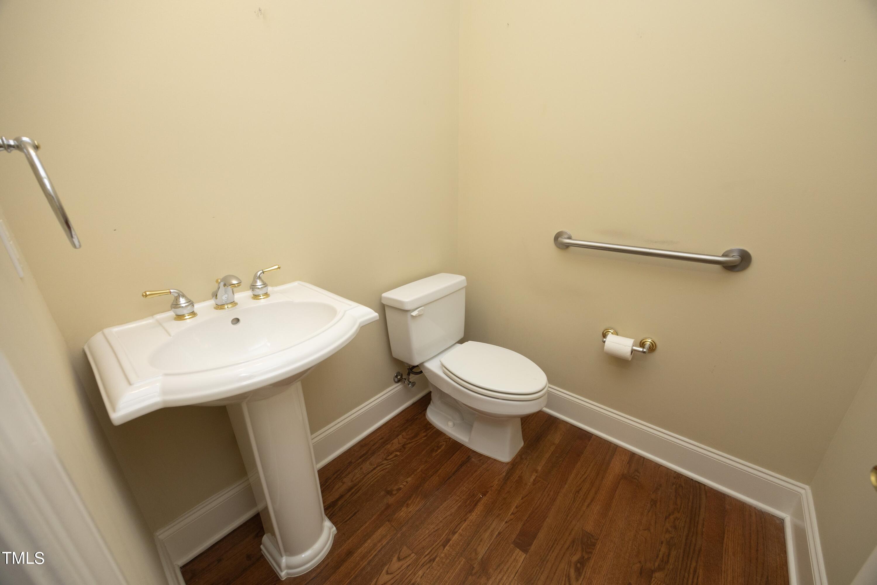 8805 Leeshire Lane Raleigh, NC 27615 - Photo 21 of 26 a bathroom with a toilet a sink and mirror