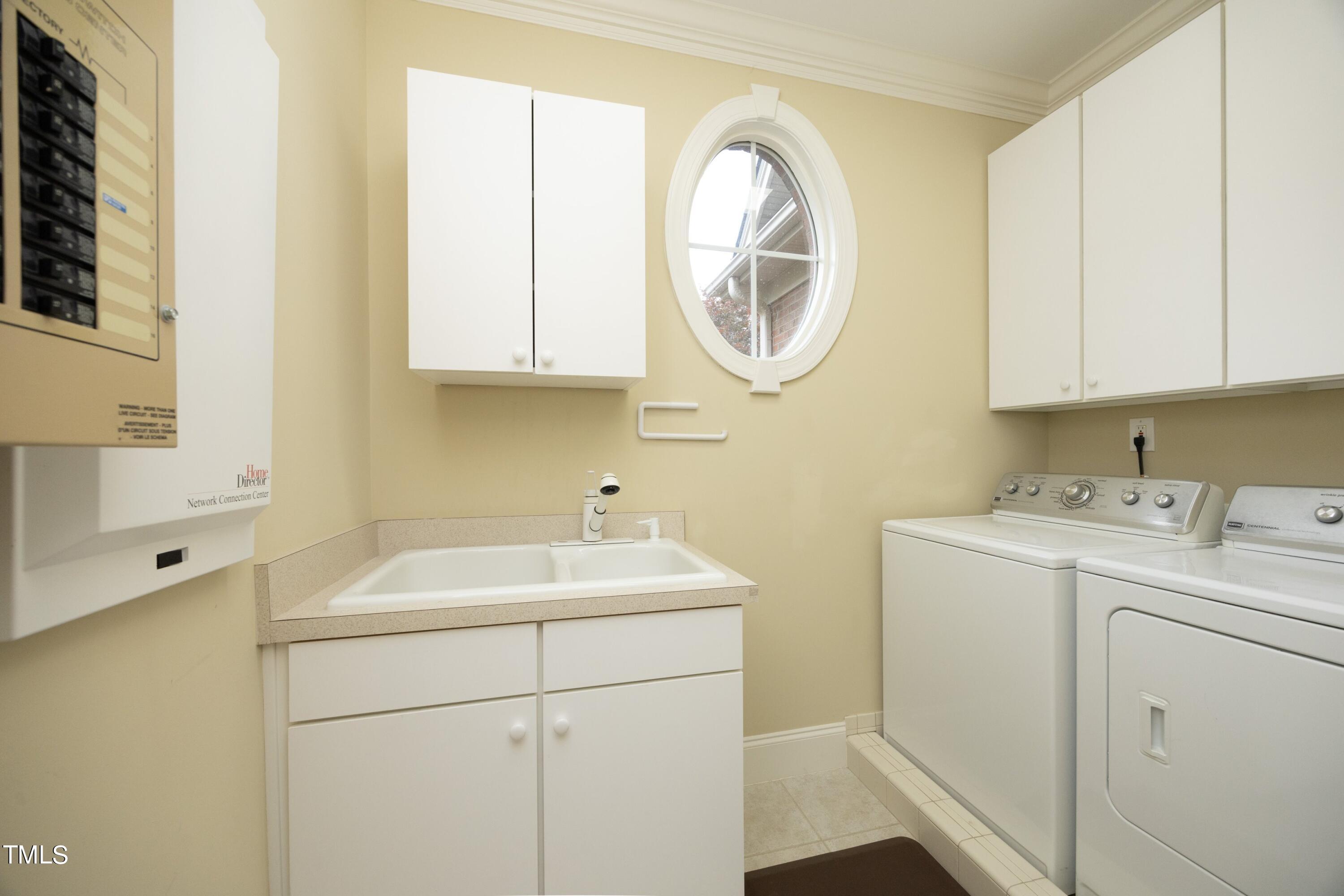 8805 Leeshire Lane Raleigh, NC 27615 - Photo 22 of 26 a utility room with dryer and washer