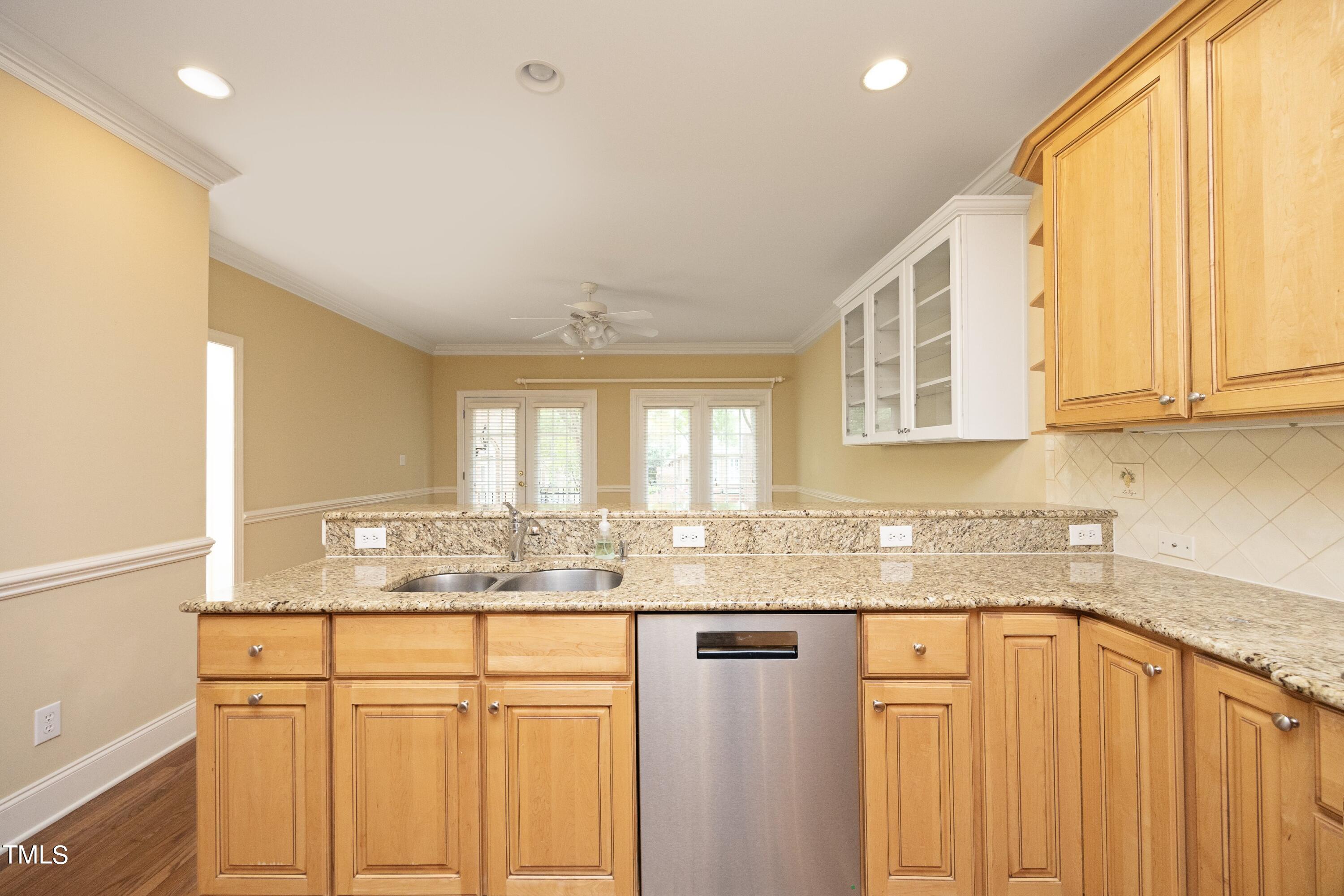 8805 Leeshire Lane Raleigh, NC 27615 - Photo 8 of 26 a kitchen with granite countertop cabinets stainless steel appliances a sink and a window