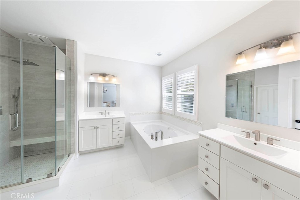 6 Teardrop Irvine, CA 92603 - Photo 28 of 42 a bathroom with a tub a sink double vanity and a shower