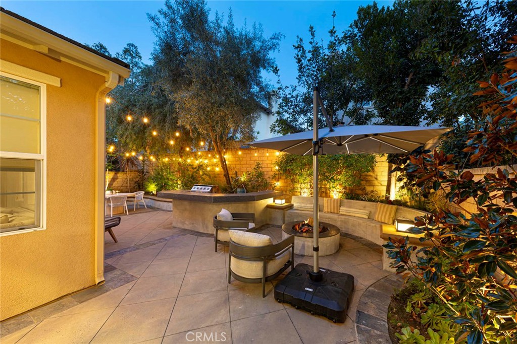 6 Teardrop Irvine, CA 92603 - Photo 36 of 42 a view of a patio with couches and table and chairs under an umbrella