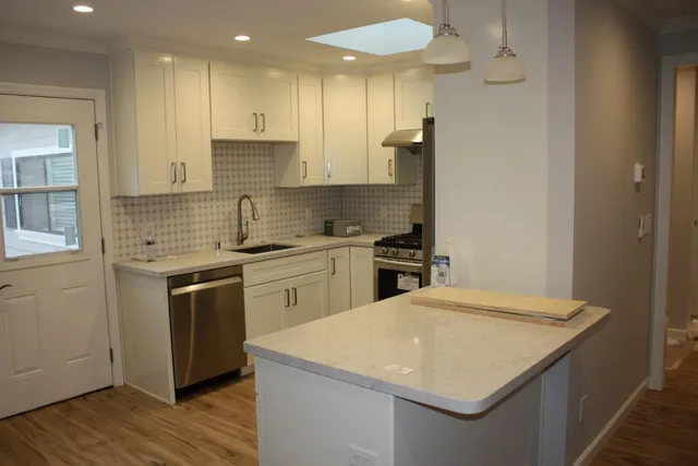 a kitchen with a stove a sink and a refrigerator