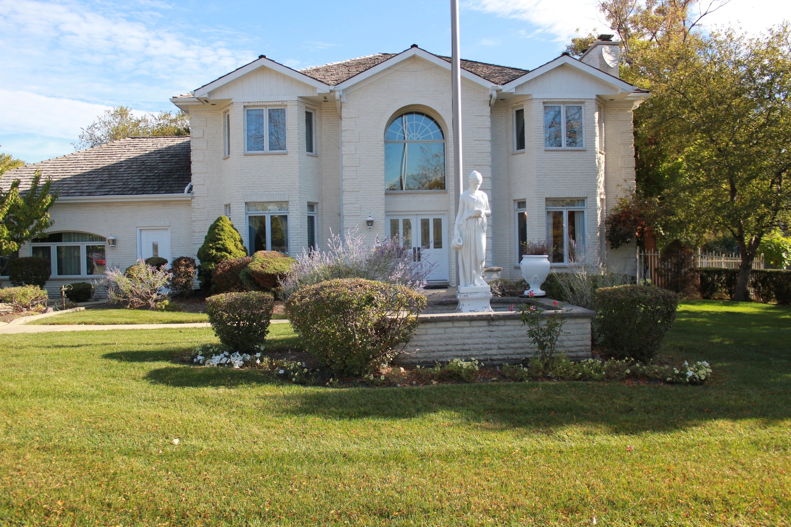 a front view of a house with a garden