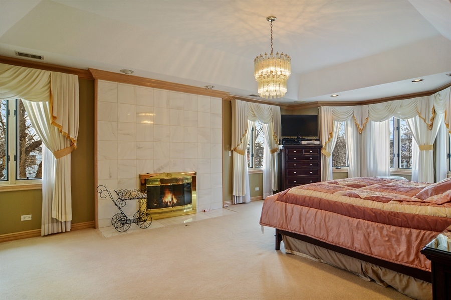 314 West Rand Road Mount Prospect, IL 60056 - Photo 15 of 27 a bedroom with a bed and a fireplace