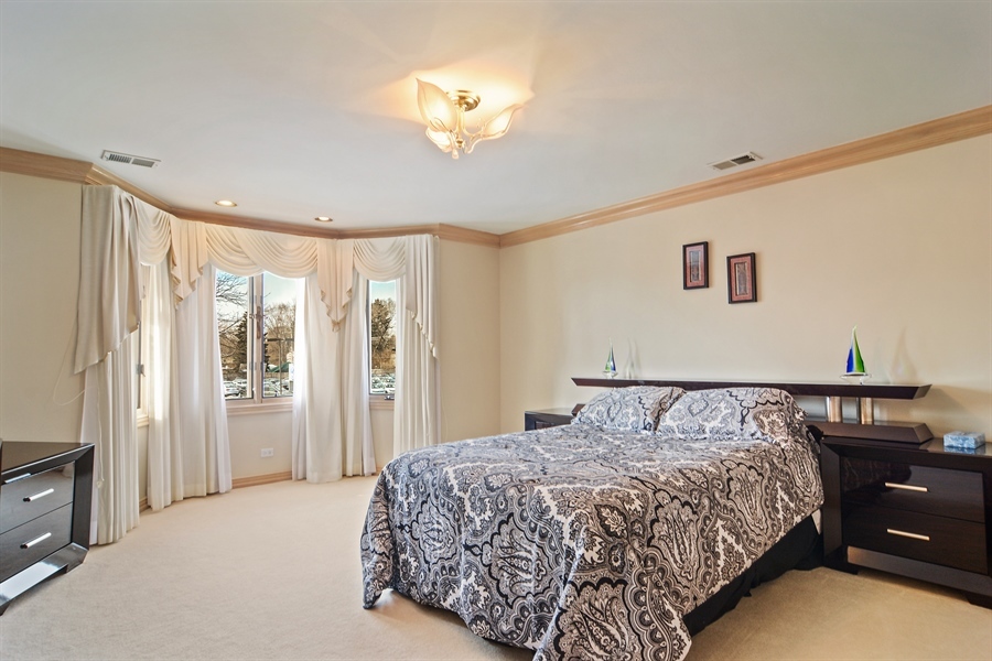 314 West Rand Road Mount Prospect, IL 60056 - Photo 17 of 27 a bedroom with a large bed and a chandelier