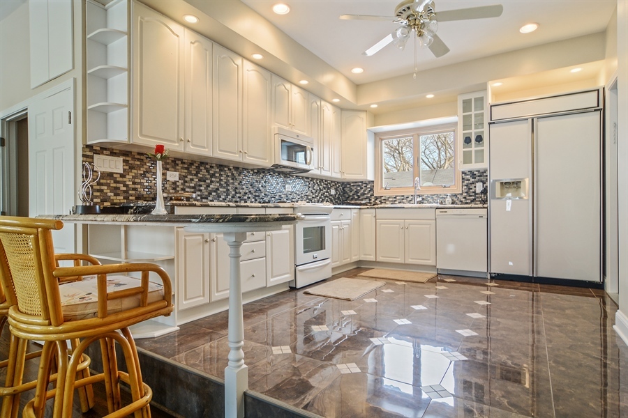 314 West Rand Road Mount Prospect, IL 60056 - Photo 18 of 27 a kitchen with stainless steel appliances granite countertop a refrigerator and cabinets