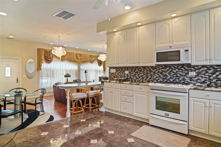 314 West Rand Road Mount Prospect, IL 60056 - Photo 19 of 27 a kitchen with a sink and white cabinets