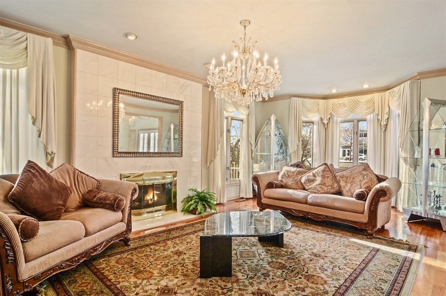 314 West Rand Road Mount Prospect, IL 60056 - Photo 7 of 27 a living room with furniture and a chandelier