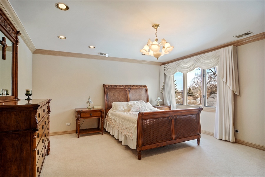 314 West Rand Road Mount Prospect, IL 60056 - Photo 9 of 27 a bed room with a bed and a chandelier