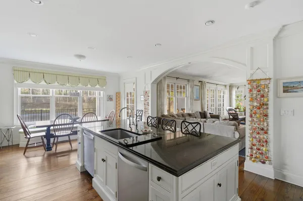 a kitchen with counter top space and wooden floor