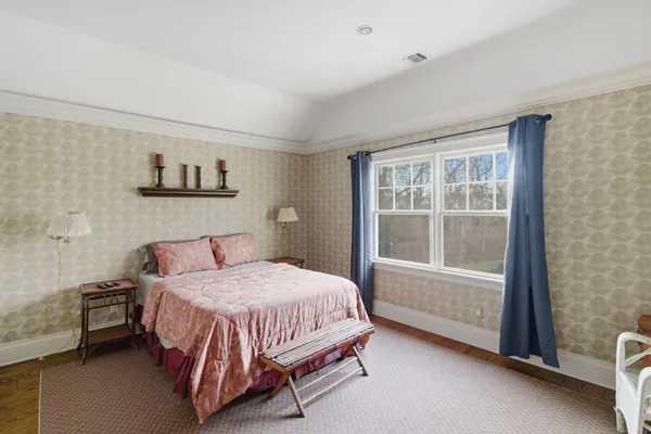 a bedroom with a bed and a window