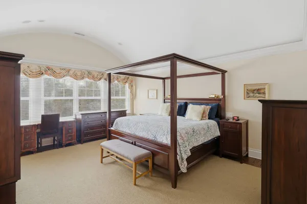 a bedroom with a bed chair and window