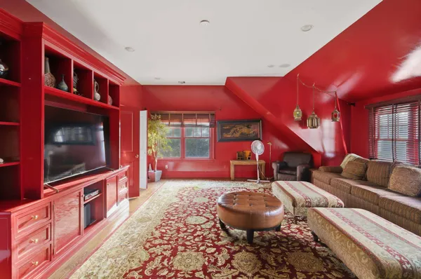 a living room with furniture a flat screen tv and kitchen view