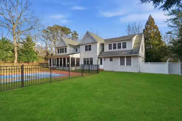 a view of a house with a yard and deck