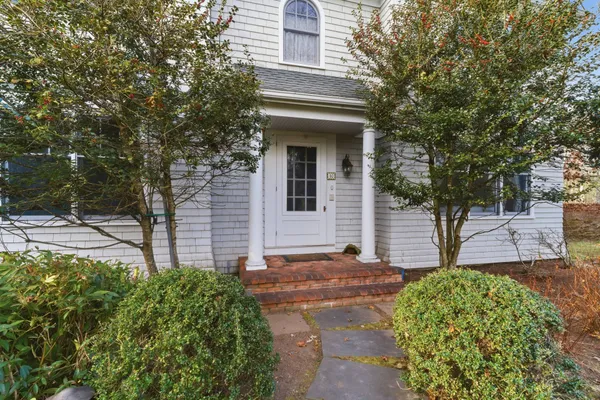 a front view of a house with garden