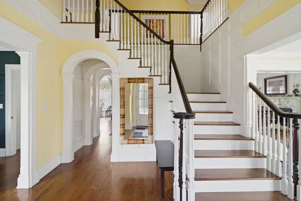 a view of entryway and hall with wooden floor