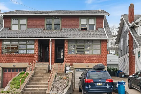 a front view of a house with a garden