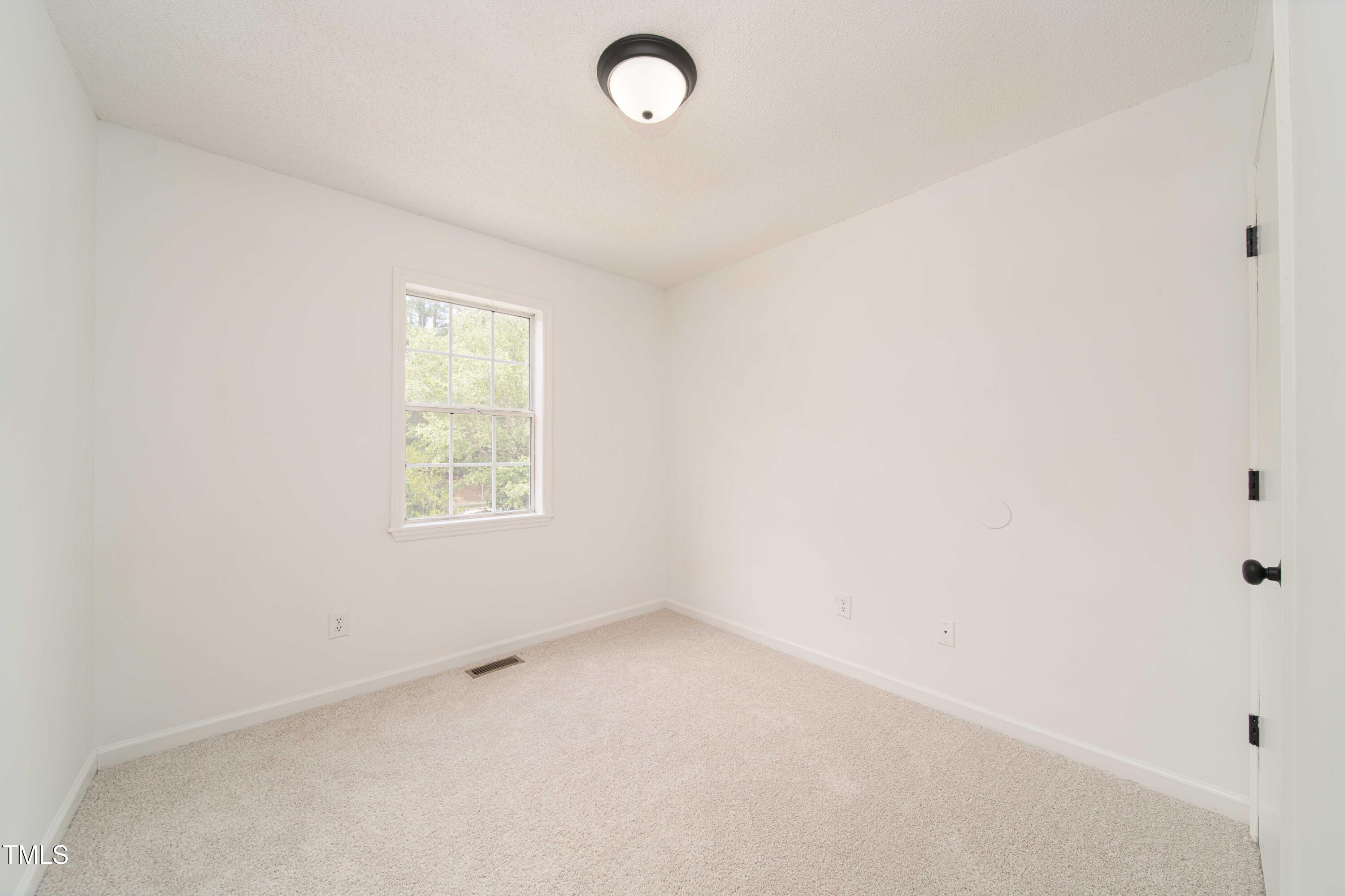 4258 Kaplan Drive Raleigh, NC 27606 - Photo 12 of 20 an empty room with a window