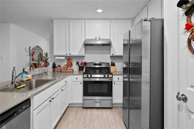 a kitchen with a sink stove and cabinets