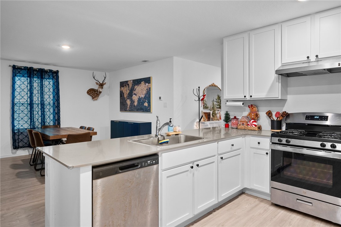 1118 Demeter Drive Portland, TX 78374 - Photo 12 of 28 a kitchen with a sink stove and cabinets