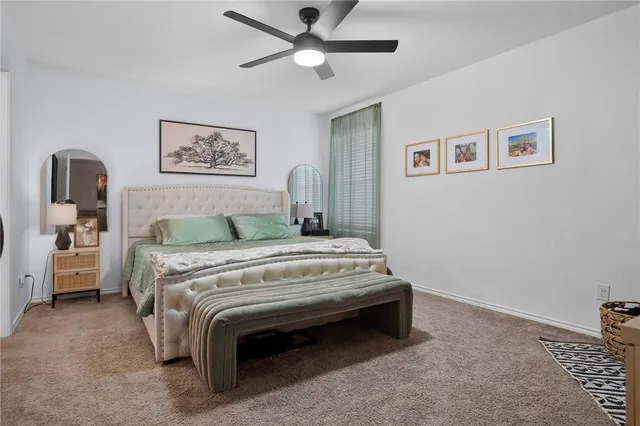 a bedroom with a bed and flat screen tv
