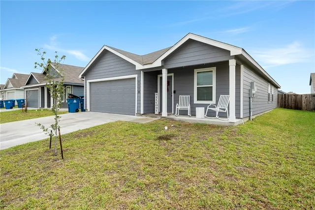 a house view with swimming pool in front of it