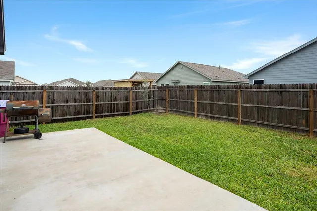 a view of a backyard with furniture and a garden