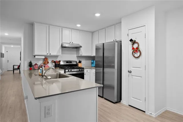 a kitchen with a sink stainless steel appliances and cabinets