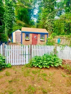 a view of a house with wooden fence