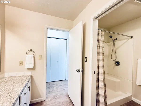 a bathroom with a granite countertop shower mirror and a sink