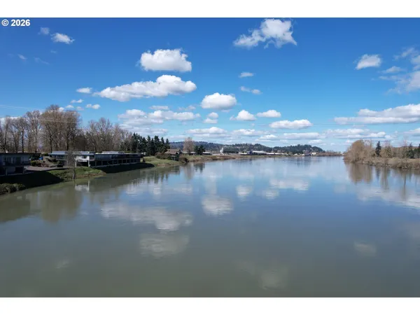 a view of a lake with houses in the background