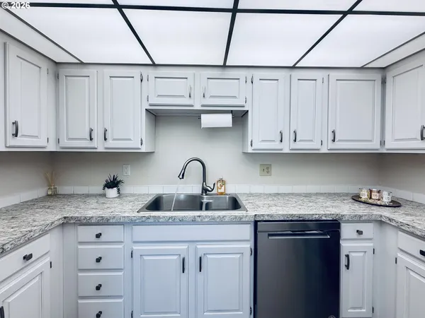 a kitchen with stainless steel appliances granite countertop a sink and cabinets