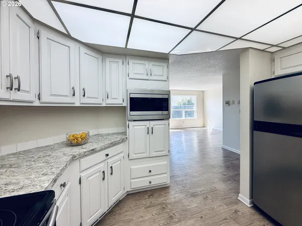 a kitchen with stainless steel appliances granite countertop a refrigerator and microwave