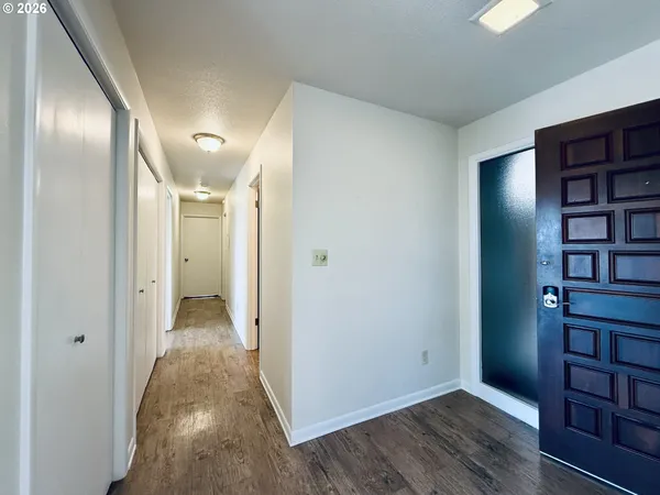 a view of a hallway with wooden floor