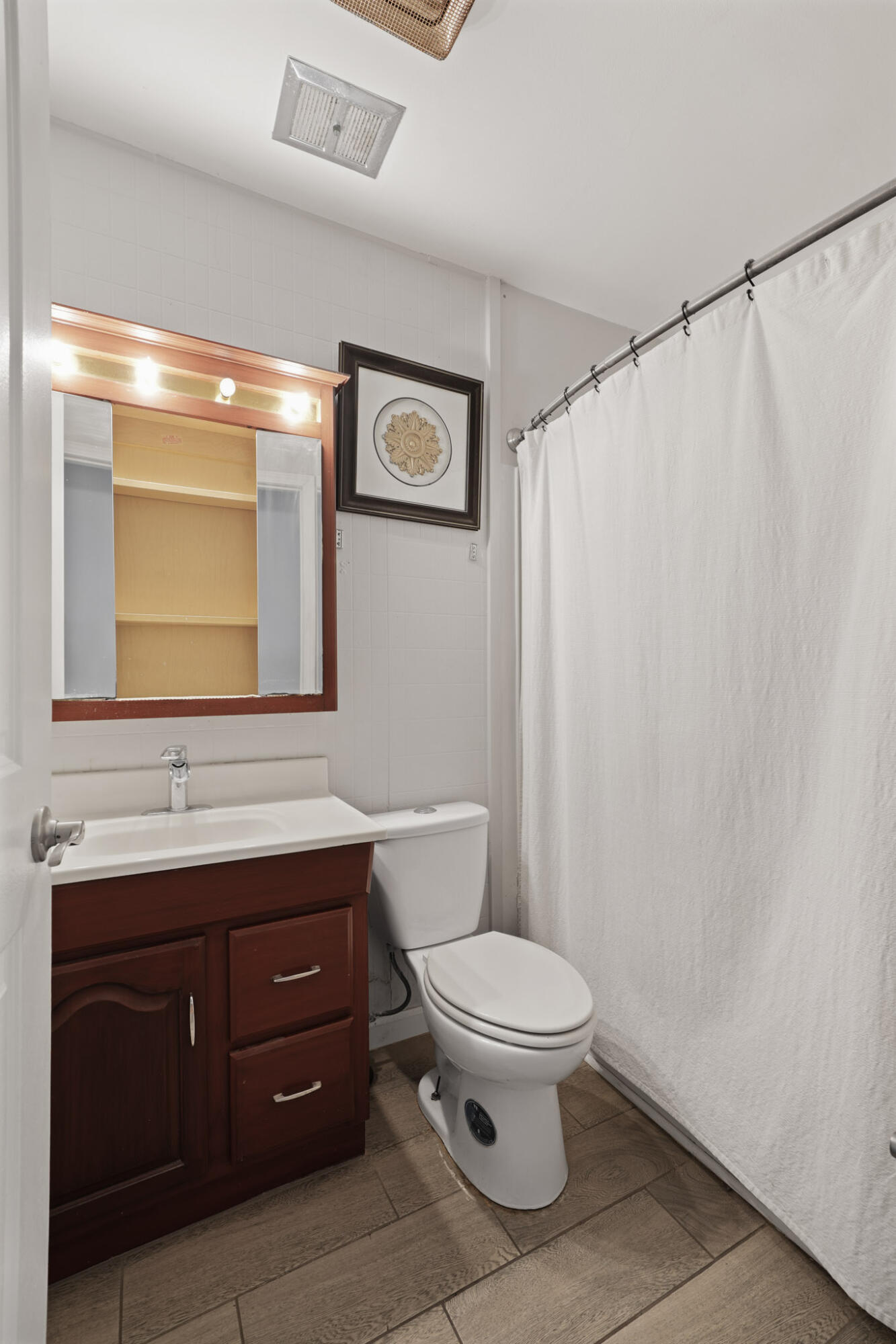 3339 Windy Hill Road Crown Point, IN 46307 - Photo 19 of 25 a bathroom with a toilet a sink and a mirror