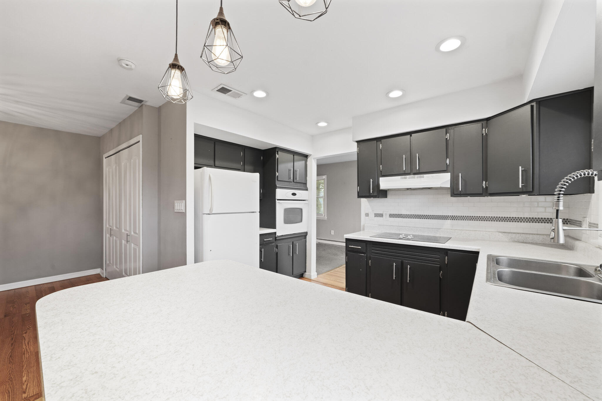 3339 Windy Hill Road Crown Point, IN 46307 - Photo 5 of 25 a kitchen with stainless steel appliances granite countertop a refrigerator a sink dishwasher a stove and white cabinets with wooden floor