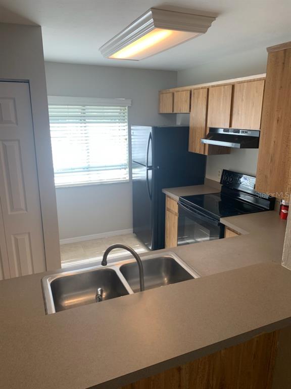 6206 Southwest 8th Lane Gainesville, FL 32607 - Photo 6 of 15 a kitchen with a sink a stove and a window
